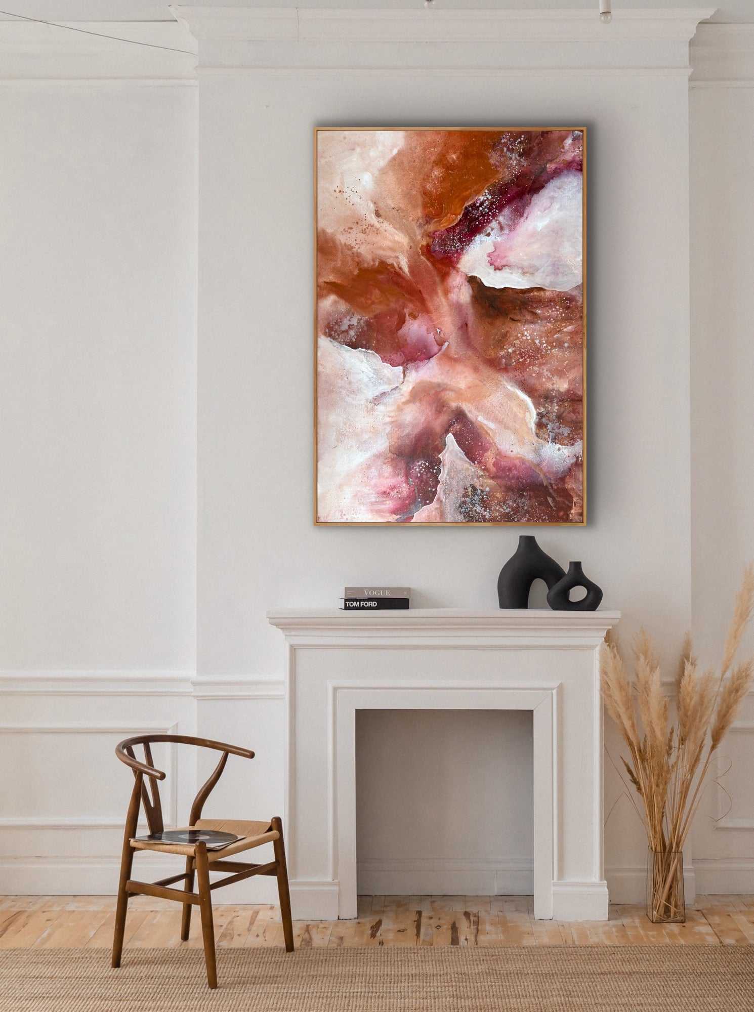 Abstract painting on a wall above a fireplace with a chair and decorative items.