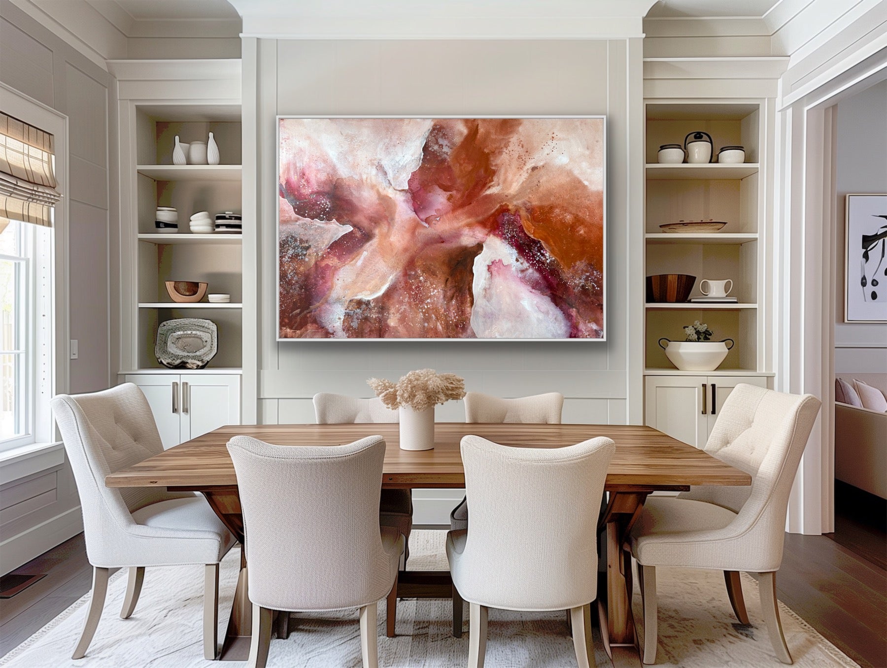 Dining room with a wooden table and white chairs, abstract painting on the wall, and shelves with decor items.