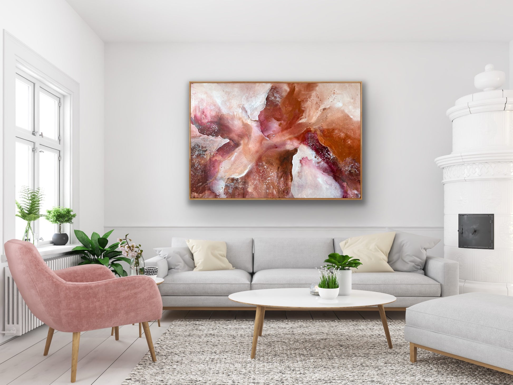 Living room with a gray sofa, pink armchair, and abstract painting on the wall.