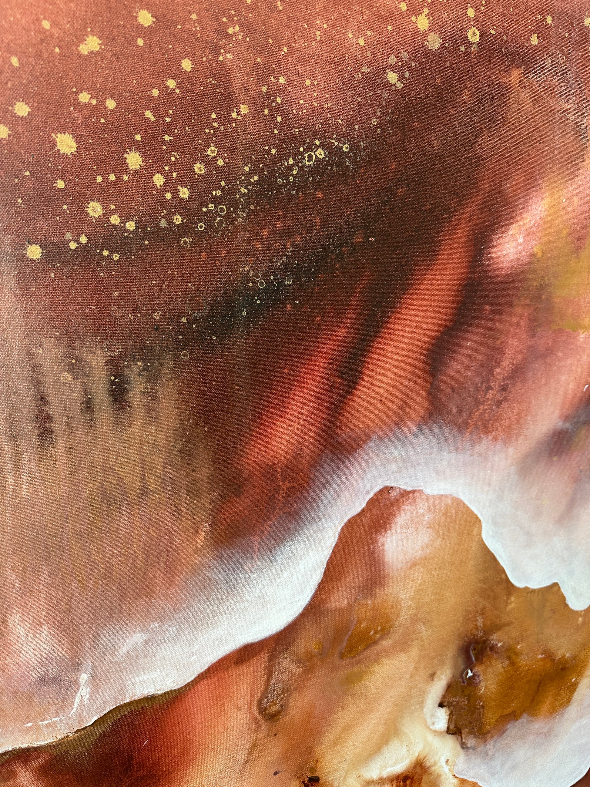 Close-up of a textured surface with brown, white, and gold colors