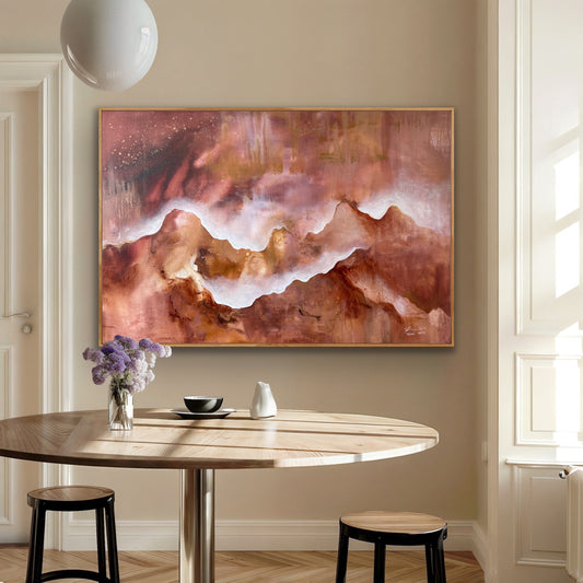 Abstract painting of a mountain on a wall above a dining table with decor items.